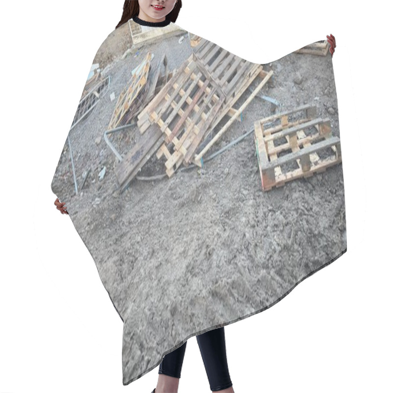 Personality  Discarded Wooden Pallets And A Damaged Metal Fence Lie On Muddy Ground. The Scene Appears To Be A Construction Or Demolition Site.  The Pallets Are Weathered And Scattered. Hair Cutting Cape