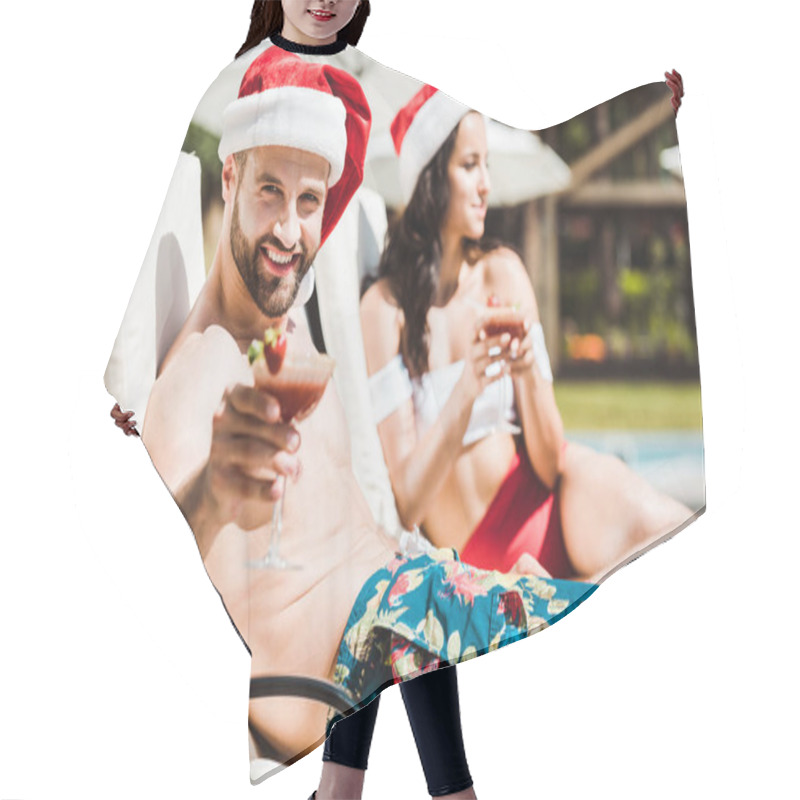 Personality  Selective Focus Of Happy Bearded Man In Santa Claus Hat Holding Cocktail Drink Near Woman  Hair Cutting Cape