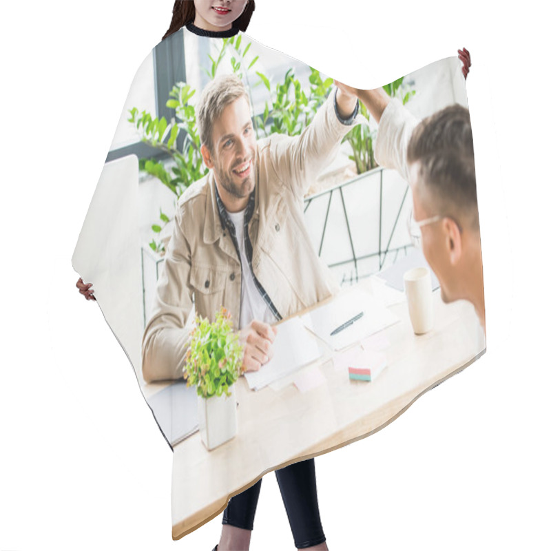 Personality  Young, Cheerful Businessmen Giving High Five While Sitting At Workplace In Office Hair Cutting Cape