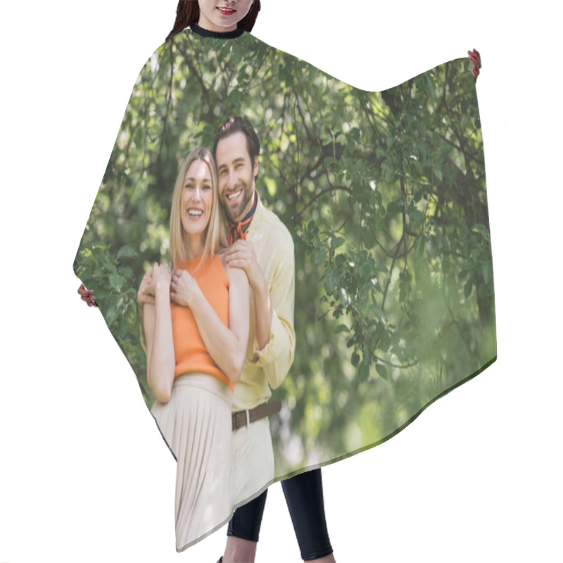 Personality  Trendy Romantic Couple Hugging And Smiling At Camera In Summer Park  Hair Cutting Cape