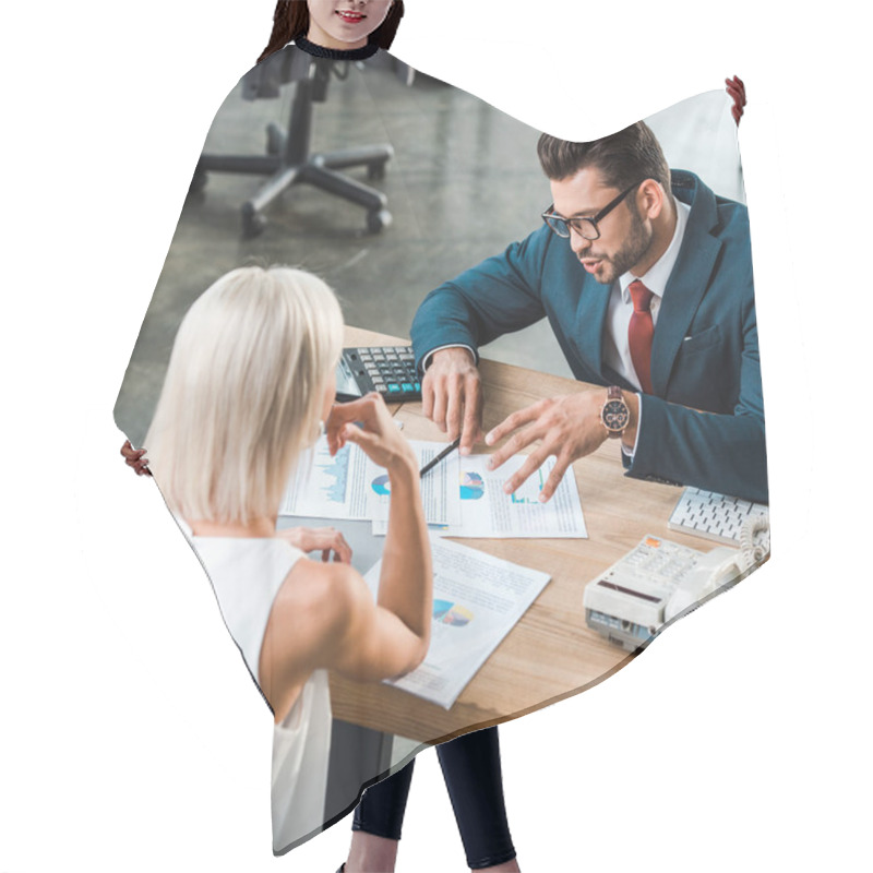 Personality  Selective Focus Of Businessman In Glasses Gesturing While Looking At Charts And Graphs Near Blonde Colleague  Hair Cutting Cape