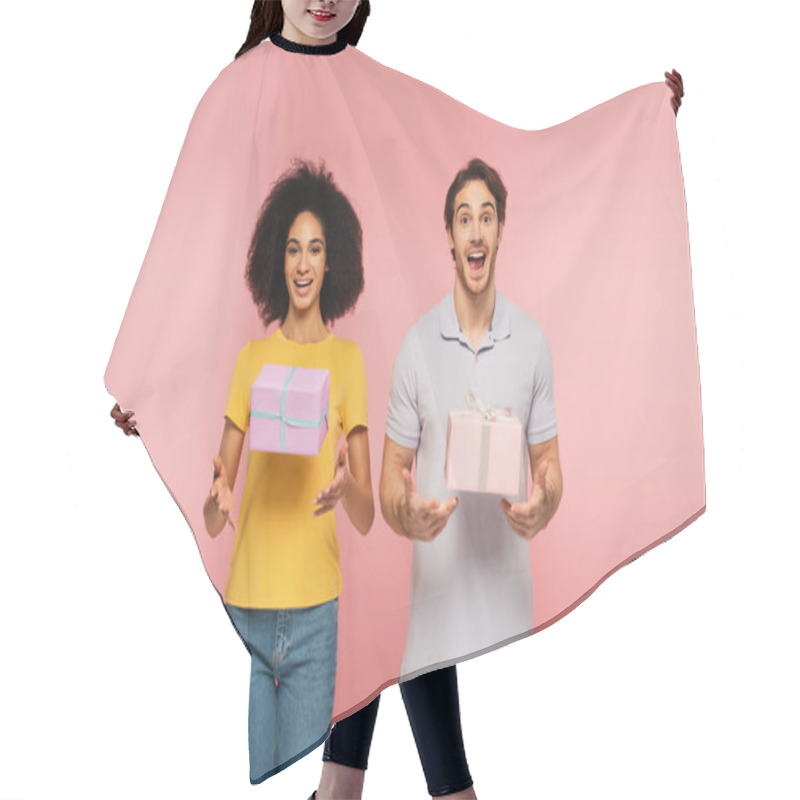 Personality  Amazed Multiethnic Couple Looking At Camera Near Flying Gift Boxes Isolated On Pink Hair Cutting Cape