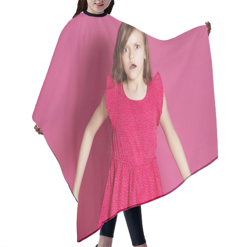 Personality  Little 8 Years Old Girl Make Some Emotional Gesture With Her Hands On A Pink Neutral Background. She Has Long Brunette Hair And Wear Red Summer Dress. Funny Expression On Her Face Hair Cutting Cape