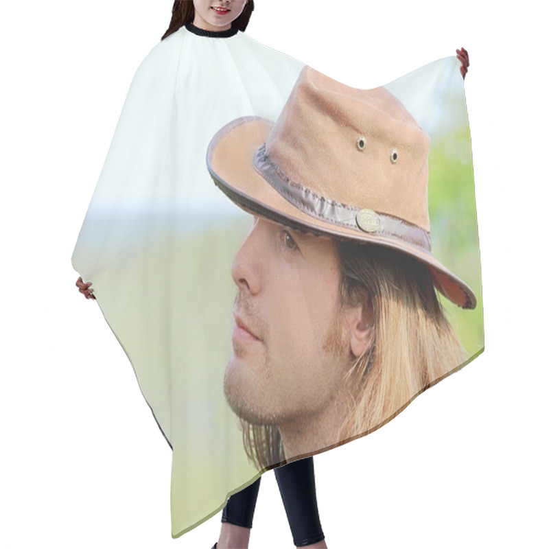 Personality  Close-up Portrait Of Handsome Guy With Long Hair In Cowboy Hat. Safari. Romance. Country Style. Hair Cutting Cape