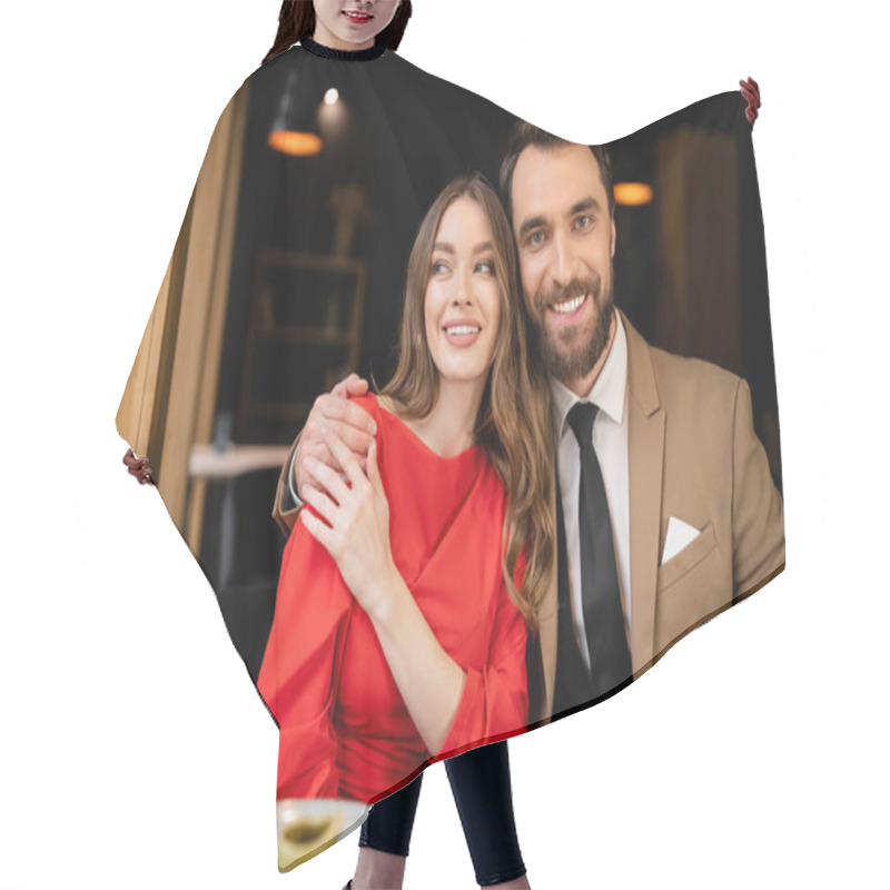 Personality  Bearded Man Hugging Cheerful Young Woman In Red Dress And Looking At Camera On Valentines Day  Hair Cutting Cape