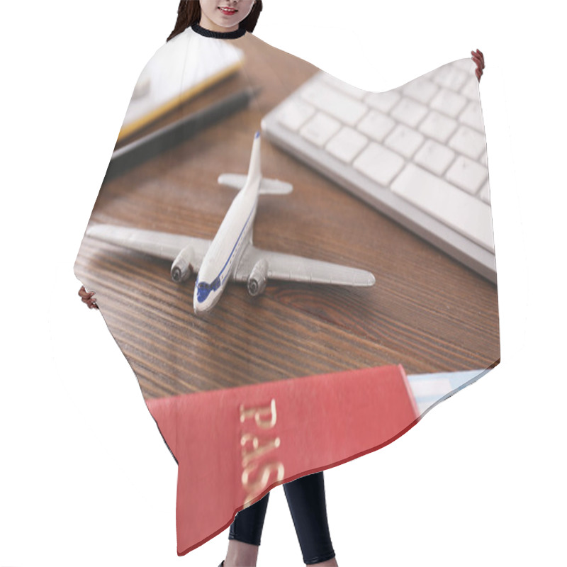 Personality  Composition With Airplane Model On Wooden Table. Travel Agency Concept Hair Cutting Cape