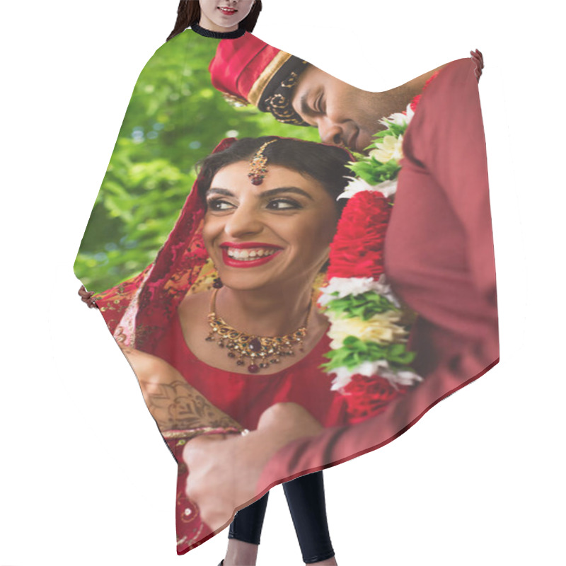 Personality  Pleased Indian Man In Turban Hugging Happy Bride In Red Sari  Hair Cutting Cape