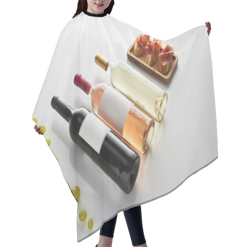 Personality  Bottles With White, Rose And Red Wine Near Grape And Sliced Prosciutto On Baguette On White Background Hair Cutting Cape