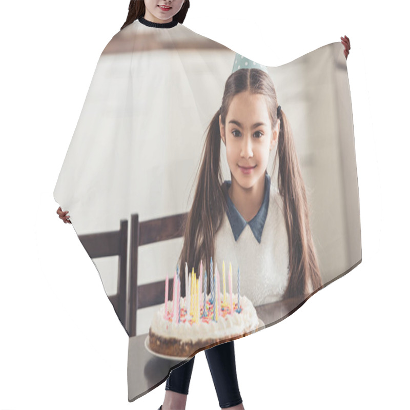 Personality  Cheerful Latin Kid In Party Cap Sitting Near Birthday Cake With Candles At Home Hair Cutting Cape