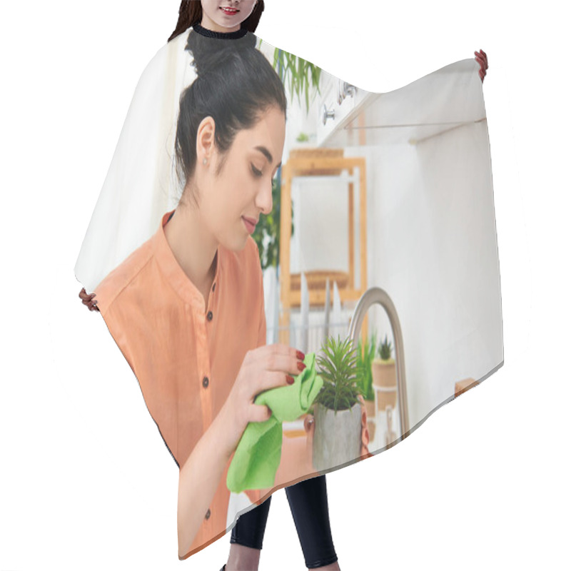 Personality  A Stylish Woman Holding A Potted Plant In A Cozy Kitchen Setting. Hair Cutting Cape