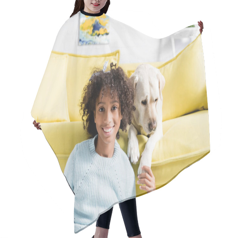 Personality  Smiling Girl Touching Labrador Paw, While Looking At Camera And Sitting Near Sofa, At Home, On Blurred Background Hair Cutting Cape