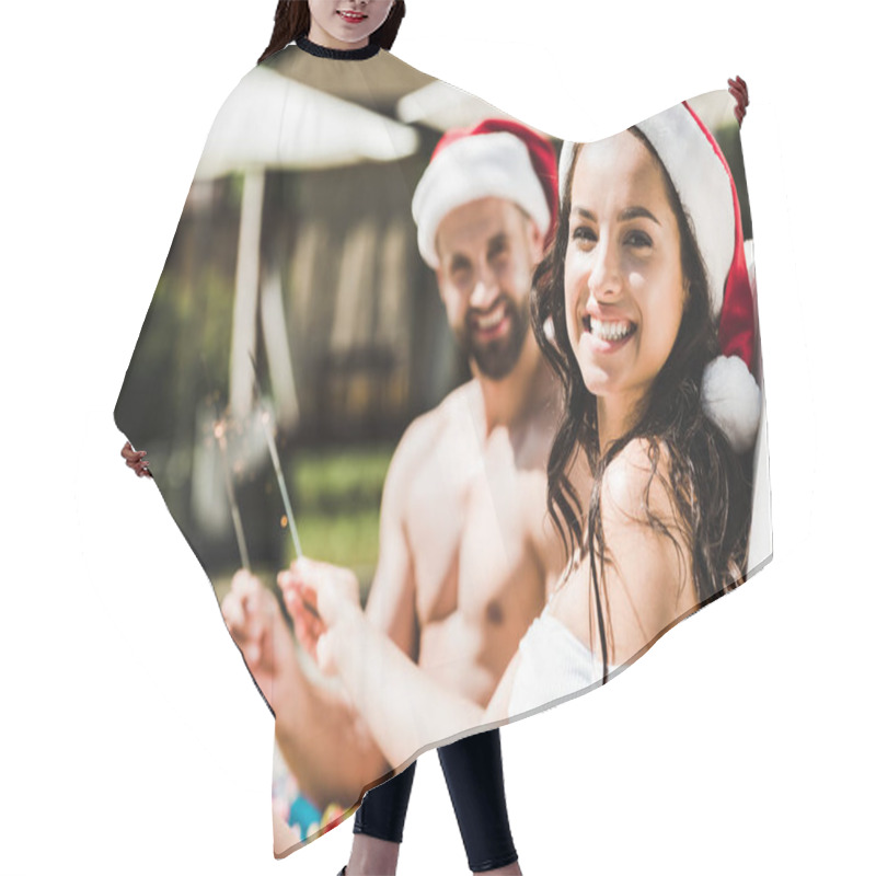 Personality  Selective Focus Of Happy Woman In Santa Claus Hat And Man Holding Sparklers  Hair Cutting Cape