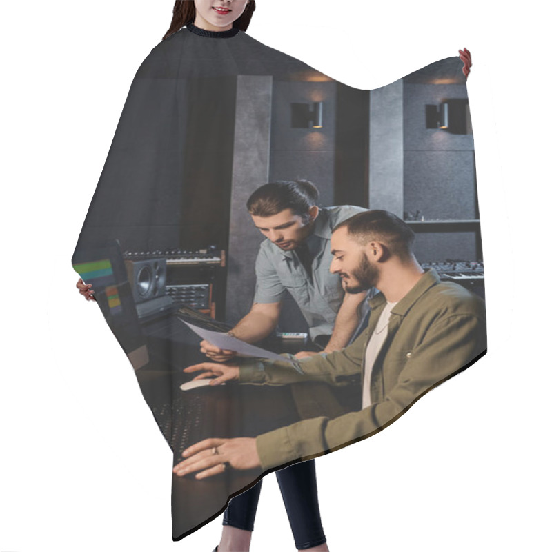 Personality  Two Men In A Recording Studio Intensely Focus On Their Computer Screen During A Music Band Rehearsal Session. Hair Cutting Cape