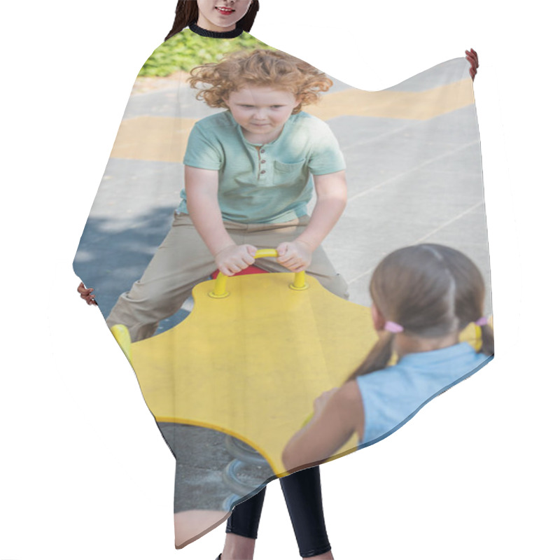 Personality  Curly Boy Riding Seesaw With Blurred Sister Outdoors Hair Cutting Cape