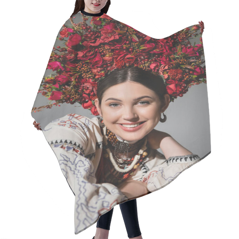 Personality  Portrait Of Joyful Ukrainian Woman In Traditional Clothes And Floral Red Wreath Isolated On Grey Hair Cutting Cape