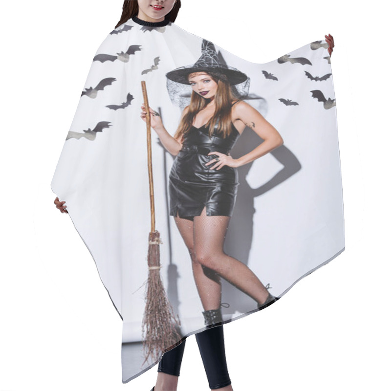 Personality  Girl In Black Witch Halloween Costume With Broom Near White Wall With Decorative Bats Hair Cutting Cape