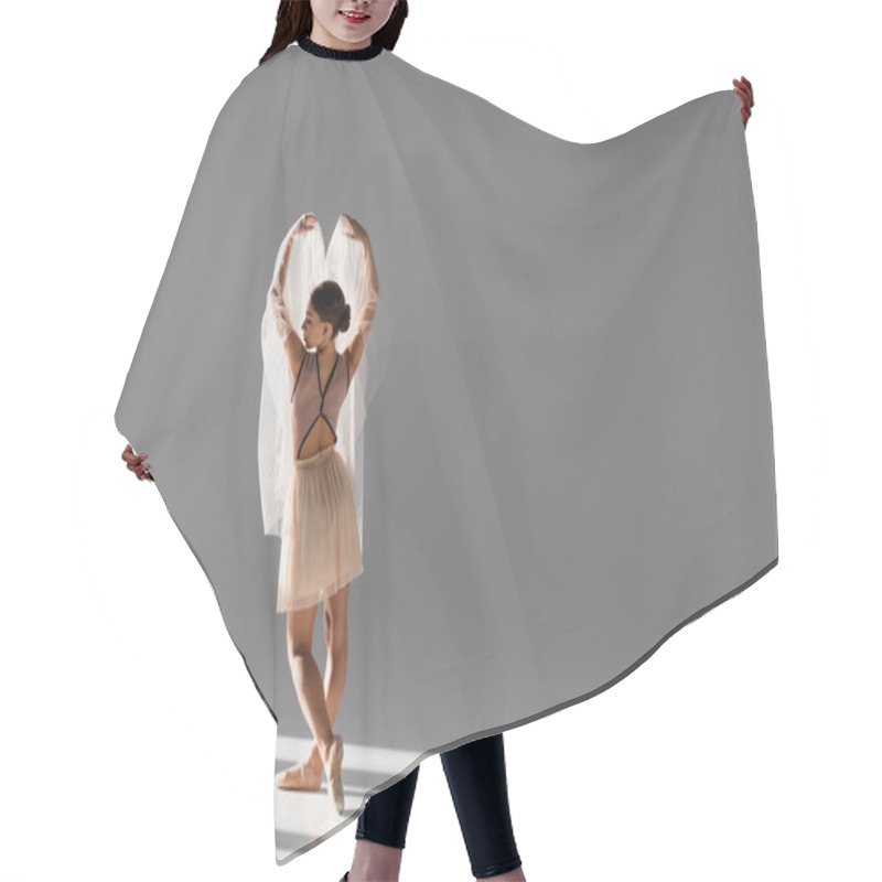 Personality  Side View Of Ballerina With Cloth Raising Hands On Grey Background With Sunlight Hair Cutting Cape