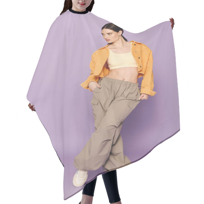 Personality  Trendy Woman In Casual Attire Showcases Modern Street Style Against A Striking Purple Background. Hair Cutting Cape