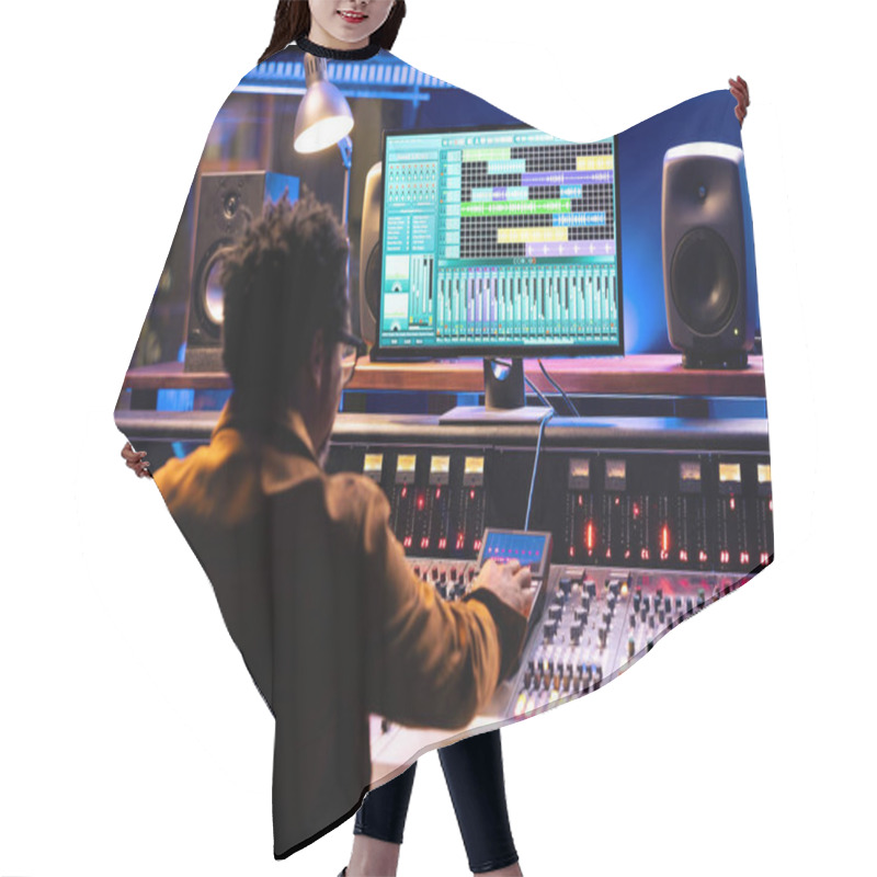 Personality  African American Audio Expert Operating Editing Software To Adjust Sound Settings, Control Room With Mixing Console In Studio. Professional Technician Creating New Tracks For An Album. Hair Cutting Cape