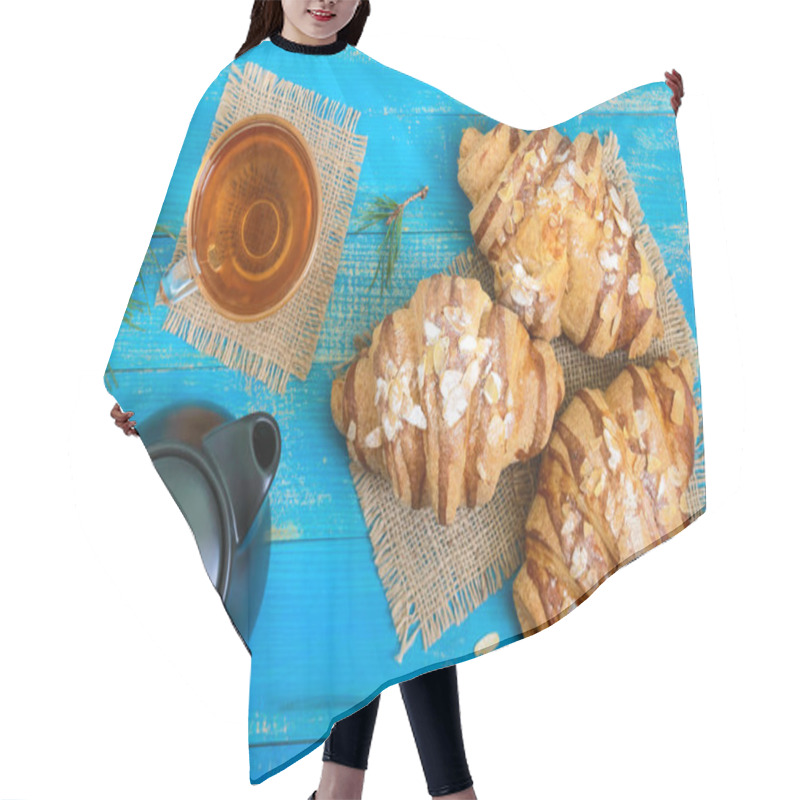 Personality  Freshly Baked Croissants With Almond Flakes, A Tea Pot And A Cup Of Tea On A Blue Wooden Background. French Pastries. Breakfast. Hair Cutting Cape