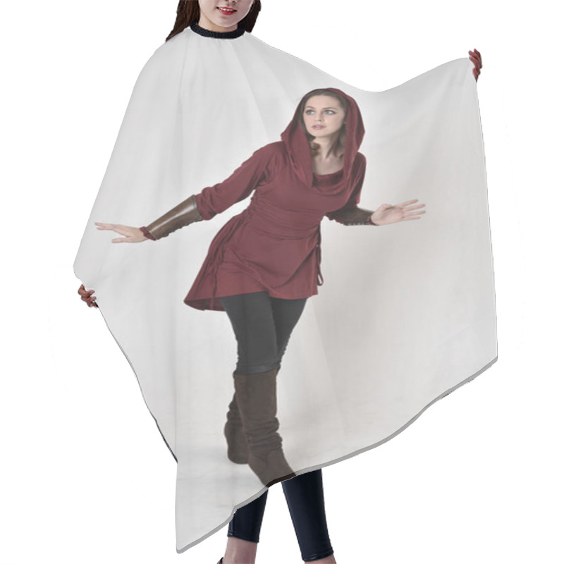 Personality  Full Length Portrait Of A Brunette Girl Wearing A Red Fantasy Tunic With Hood. Standing Pose On A White Studio Background. Hair Cutting Cape