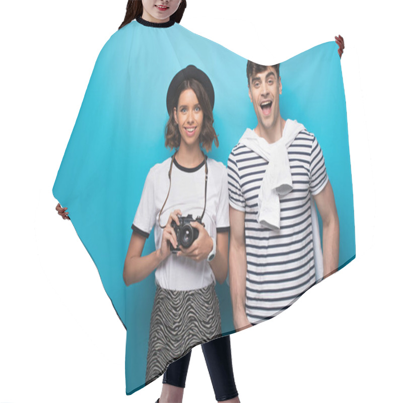 Personality  Smiling Girl With Digital Camera And Cheerful Man Looking At Camera On Blue Background Hair Cutting Cape