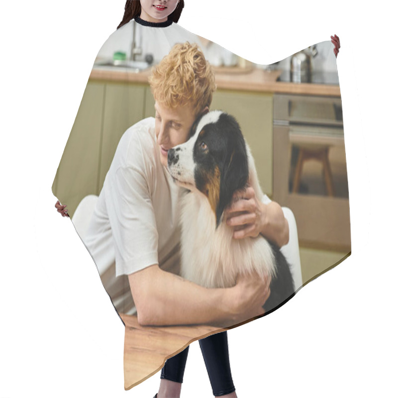 Personality  A Young Redhead Shares A Warm Embrace With His Australian Shepherd In A Stylish Kitchen. Hair Cutting Cape