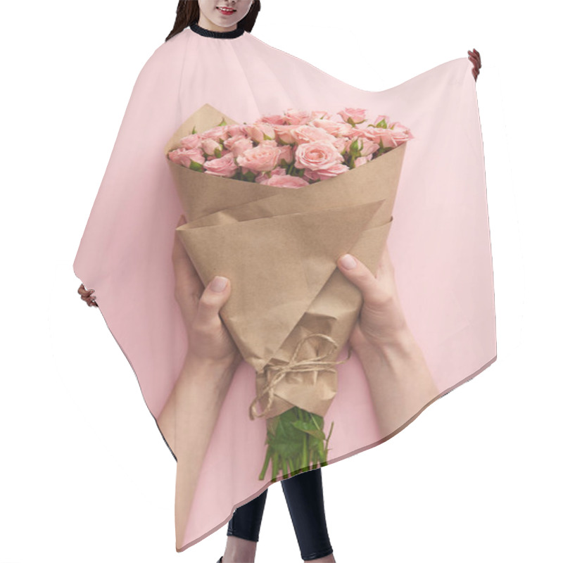 Personality  Cropped Shot Of Female Hands Holding Bouquet Of Beautiful Pink Roses Wrapped In Craft Paper On Pink Hair Cutting Cape