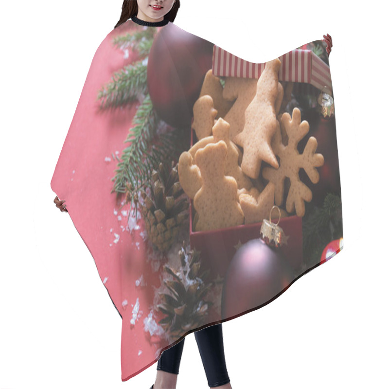 Personality  Christmas Image With A Gift Box With Cookies In Xmas Shapes, Red Globes, A Lit Candle, And Fir Twigs, On A Red Background With Snowflakes. Hair Cutting Cape