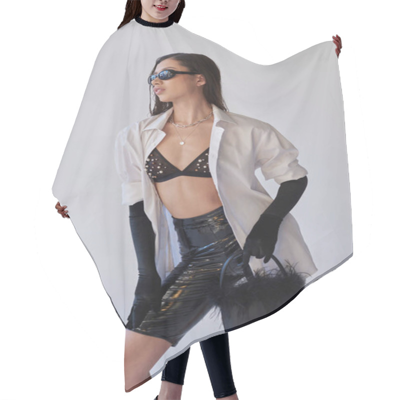 Personality  Personal Style, Fashion Forward, Asian Woman In Sunglasses Posing With Feathered Purse On Grey Background, Young Model In Latex Shorts, Black Gloves And White Shirt, Conceptual  Hair Cutting Cape