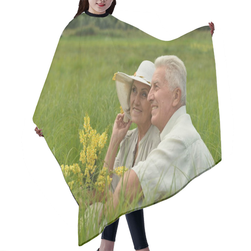 Personality  Happy Senior Couple Sitting On Green Grass  Hair Cutting Cape