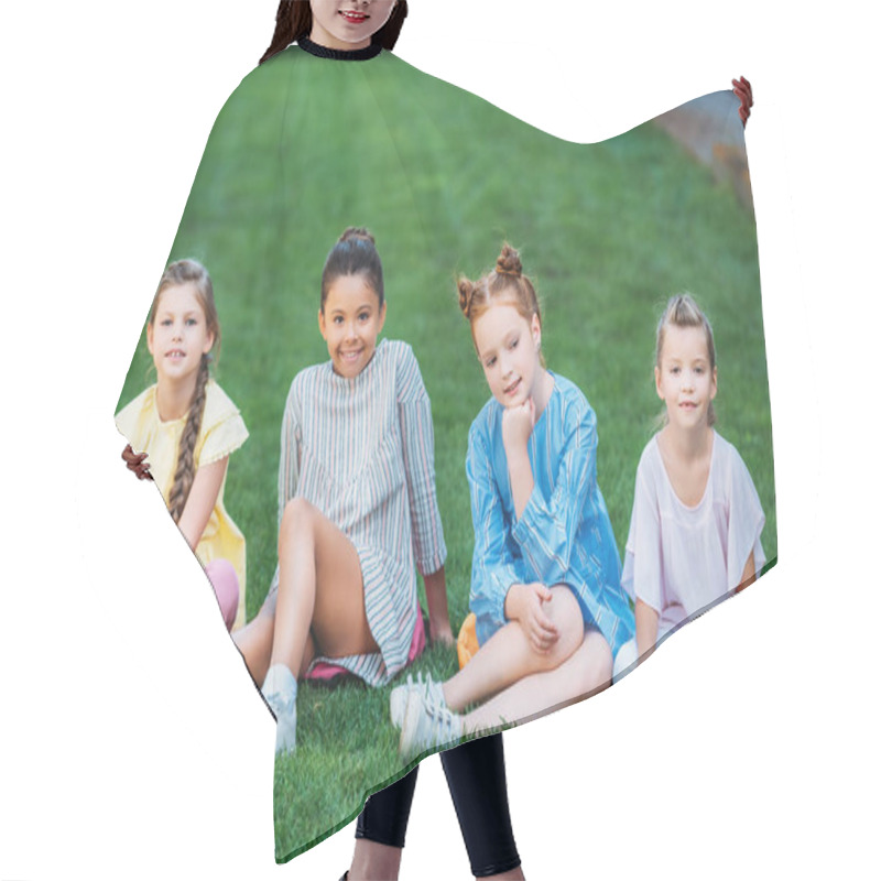 Personality  Group Of Adorable Schoolgirls Sitting On Green Grass Together And Looking At Camera Hair Cutting Cape