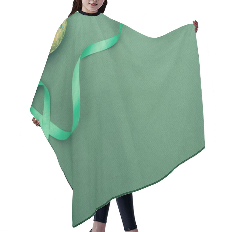 Personality  Top View Of Green Ribbon And Toy Earth On Green Background With Copy Space  Hair Cutting Cape