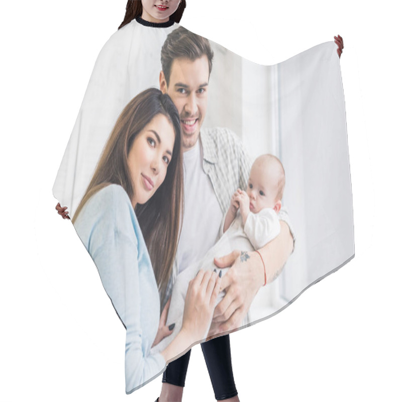 Personality  Portrait Of Young Parents With Baby At Home Hair Cutting Cape