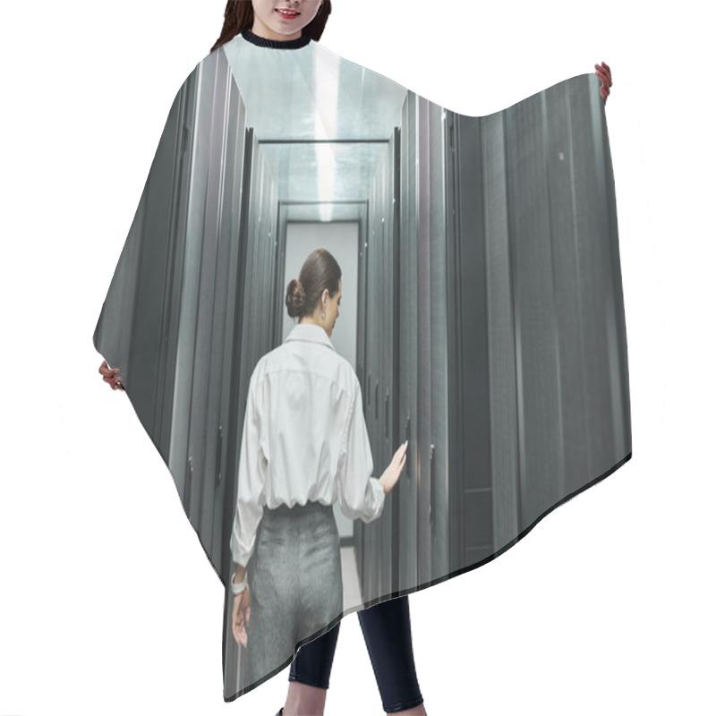 Personality  Professional Woman In A White Shirt Works Diligently Among Server Racks In A Data Center. Hair Cutting Cape