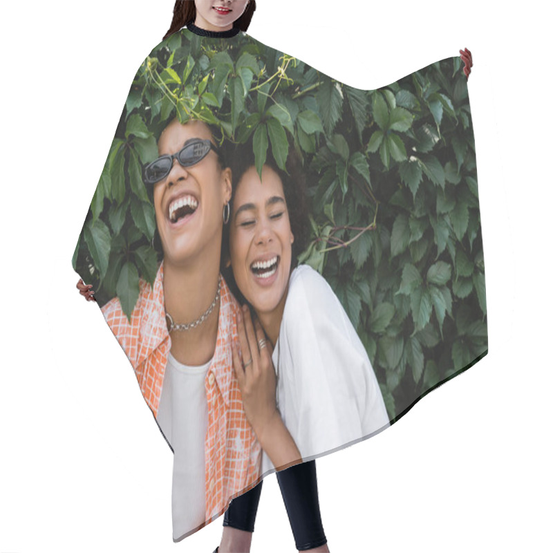 Personality  Happy African American Lesbian Women Laughing Near Green Bush In Park  Hair Cutting Cape