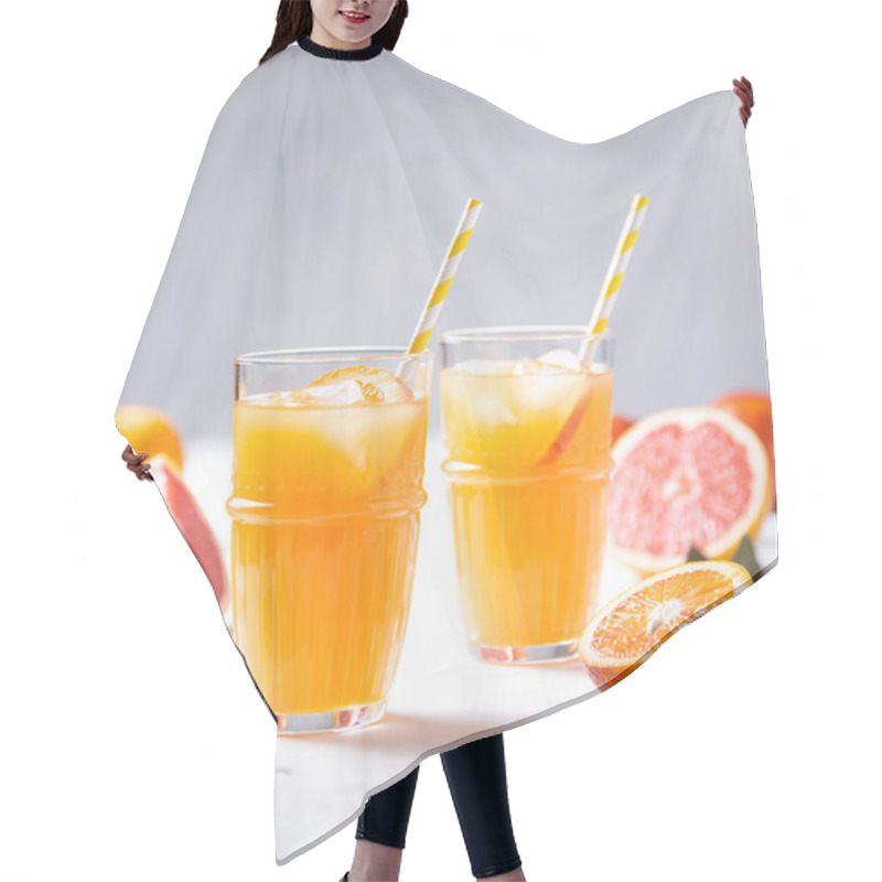 Personality  Citrus Juice In Two Glasses And Fresh Fruit Tangerine, Orange, Grapefruit And Lemon On A Gray Background. Front View And Close Up Hair Cutting Cape