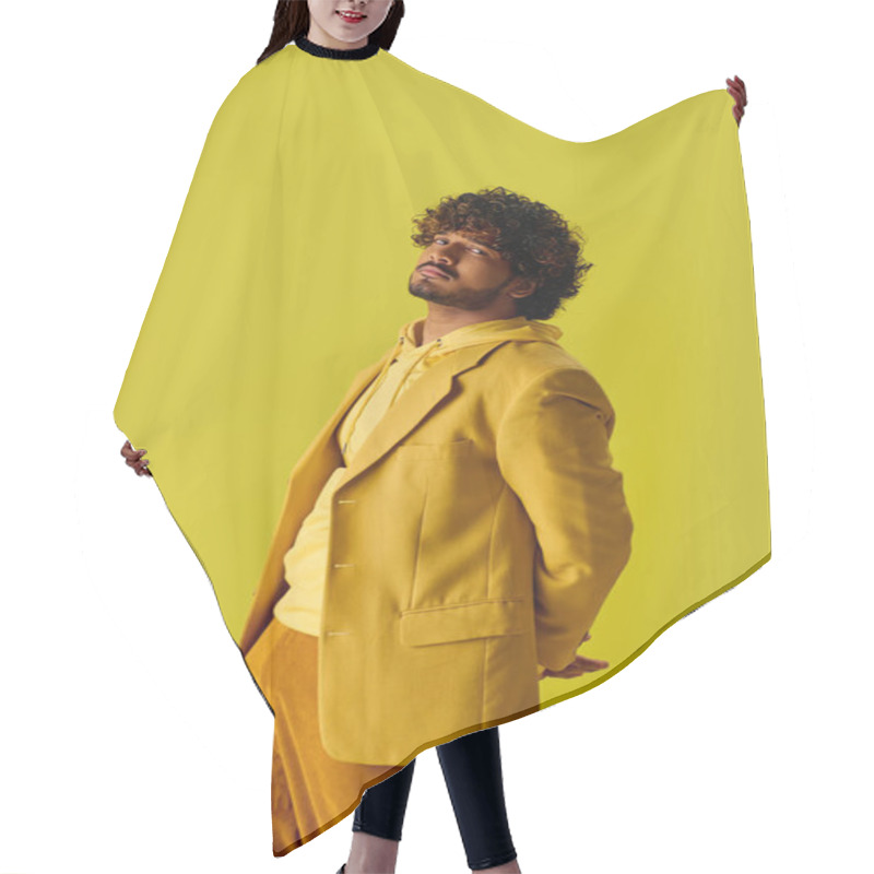 Personality  Handsome Young Indian Man In Vibrant Outfit Poses In Front Of A Bright Yellow Wall. Hair Cutting Cape