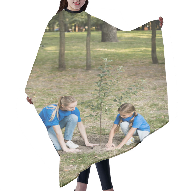 Personality  Daughter With Mother Planting Young Tree In Park, Ecology Concept Hair Cutting Cape