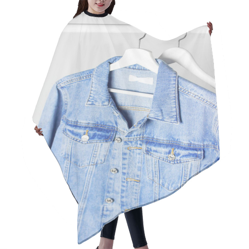 Personality  Blue Denim Jacket On White Wooden Coat Hanger On A Rod Against Light Gray Wall Flat Lay Copy Space. Denim, Fashionable Jacket, Women's Or Men's Trend Clothing, Fashion Background. Store Concept, Sale Hair Cutting Cape