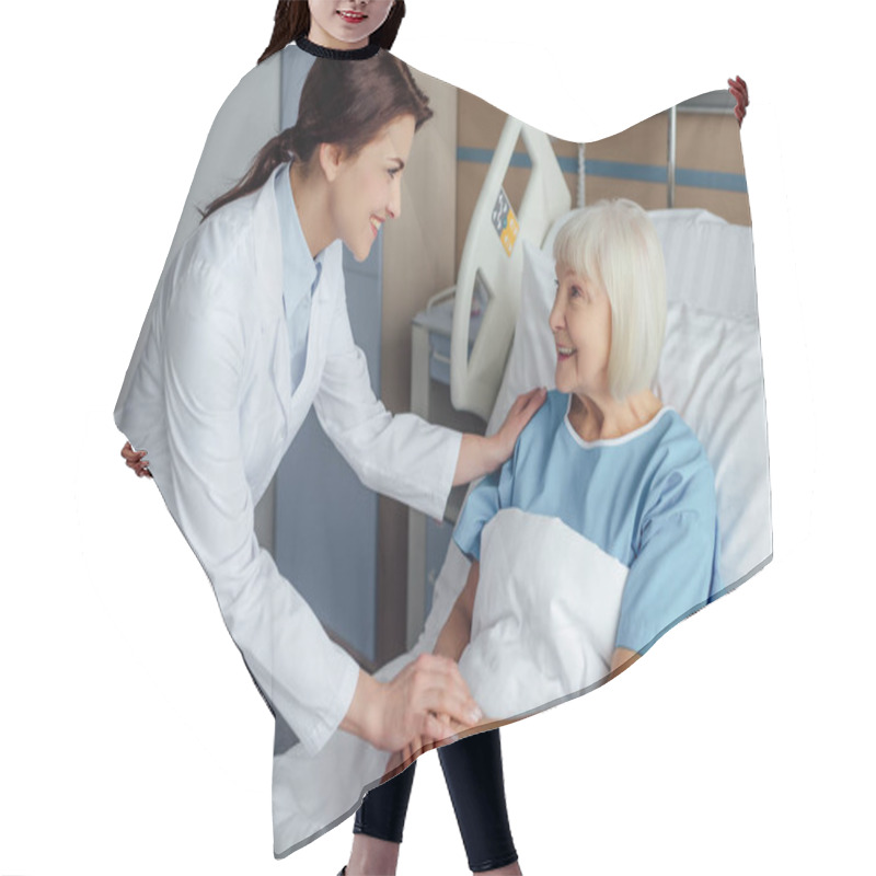 Personality  Happy Female Doctor Holding Hands And Consulting Senior Woman Lying In Hospital Bed Hair Cutting Cape