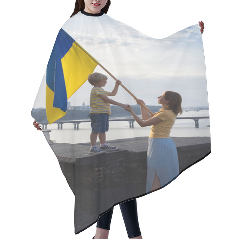 Personality  Woman And Child With Ukrainian Flag Stand On Roof Of House Against Backdrop Of Sky, Dnieper River In Kyiv. Patriotism, Drawing Attention To War In Ukraine. Support Ukraine, Hope And Faith In Victory Hair Cutting Cape