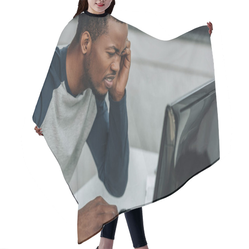 Personality  Displeased African American Programmer Looking At Computer Monitor In Office Hair Cutting Cape