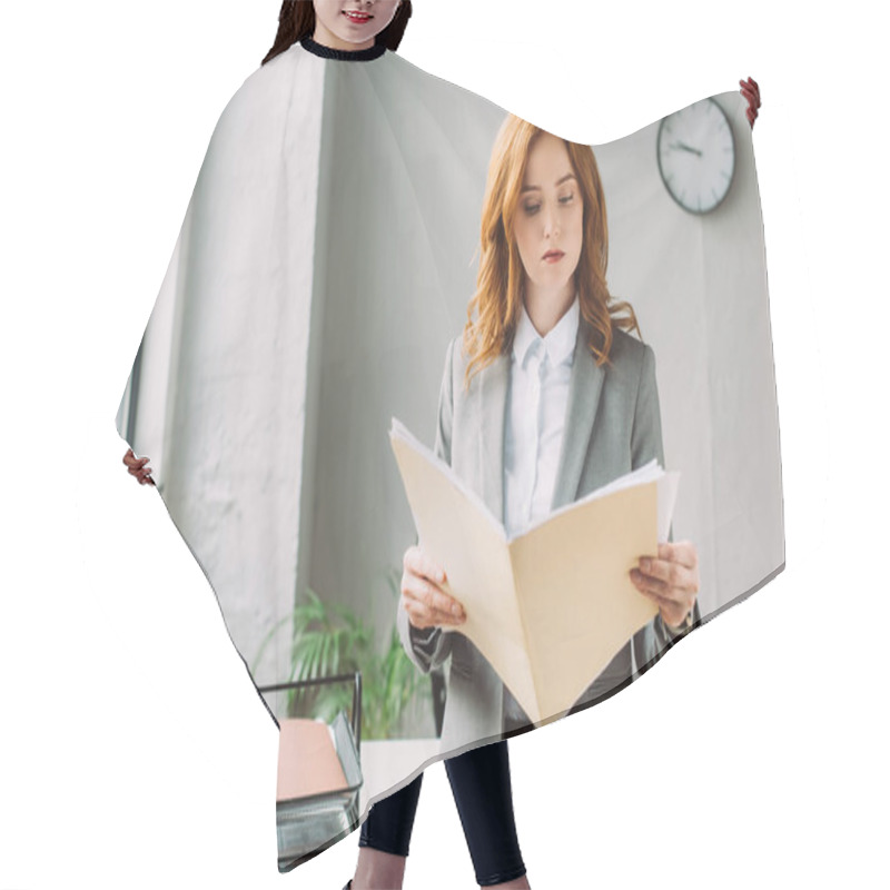 Personality  Serious Businesswoman Looking At Folder With Documents, While Standing Near Workplace On Blurred Background Hair Cutting Cape