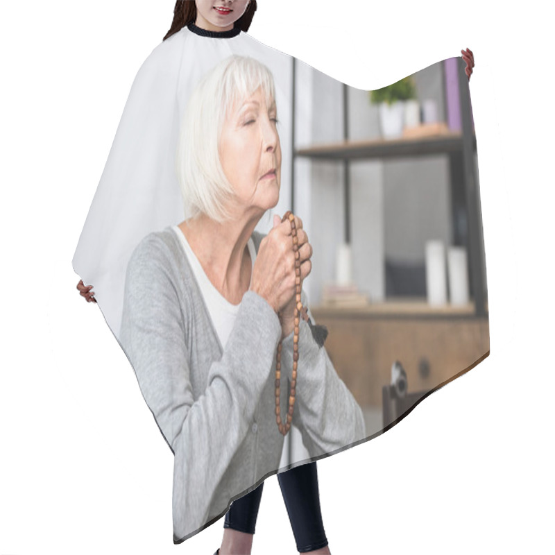 Personality  Senior Woman Holding Wooden Rosary And Praying With Closed Eyes Hair Cutting Cape