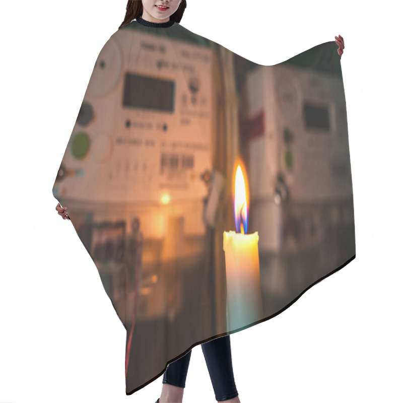 Personality  Electricity Meter Illuminated By The Light Of A Burning Candle. Power Outage, Energy Crisis Or Blackout Concept Image. Hair Cutting Cape