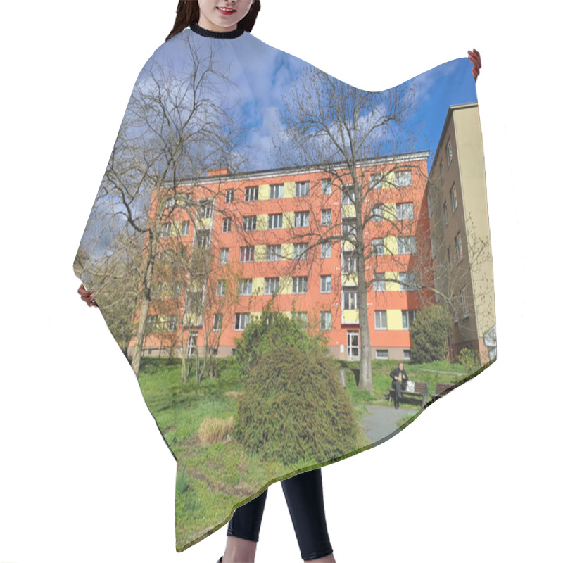 Personality  Prague, Czech Republic - April 1, 2023: Pink Block Of Flats With A Small Park In The Foreground. Hair Cutting Cape