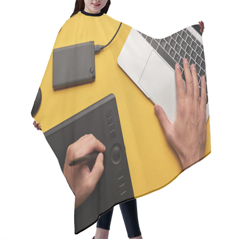 Personality  Cropped Shot Of Graphics Designer Working With Laptop And Graphics Tablet On Yellow Surface Hair Cutting Cape