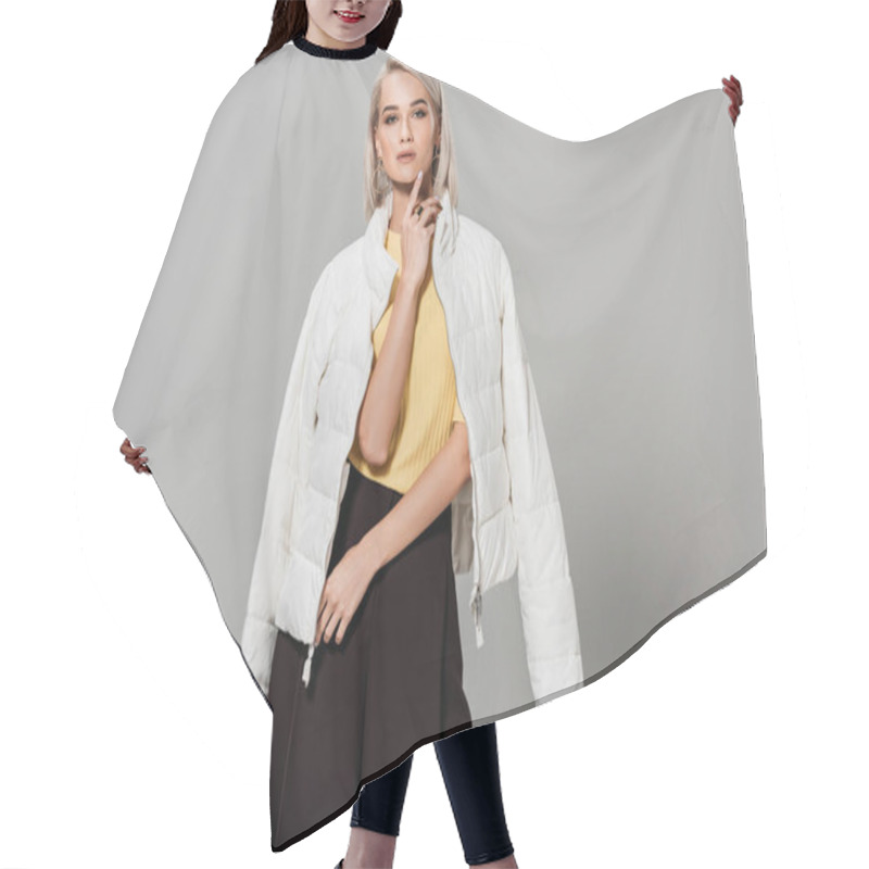 Personality  Confident Young Female Model In White Jacket Over Shoulders Posing Isolated On Grey Background Hair Cutting Cape