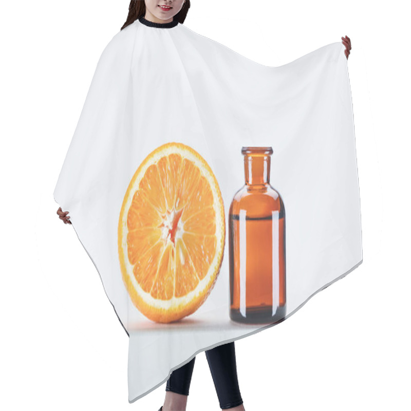 Personality  Bottle Of Natural Herbal Essential Oil And Cut Orange On White Cube Hair Cutting Cape